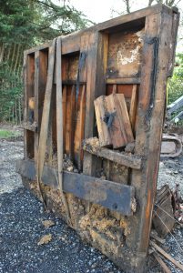 A photograph of a charred wooden piano.