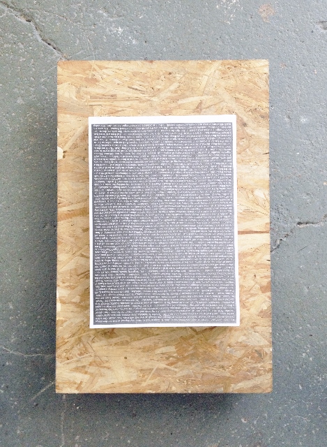 A photocopied image stuck to a piece of chipboard that is on a grey painted floor