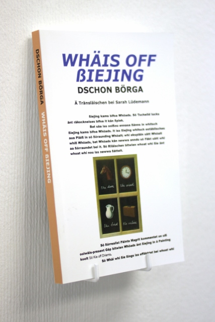 A picture of a book on a display stand on a wall. the title reads Ways of Seeing in phonetic letters.