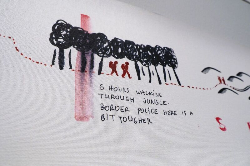 A white wall with black smudgy drawing of figures amongst trees and words underneath.