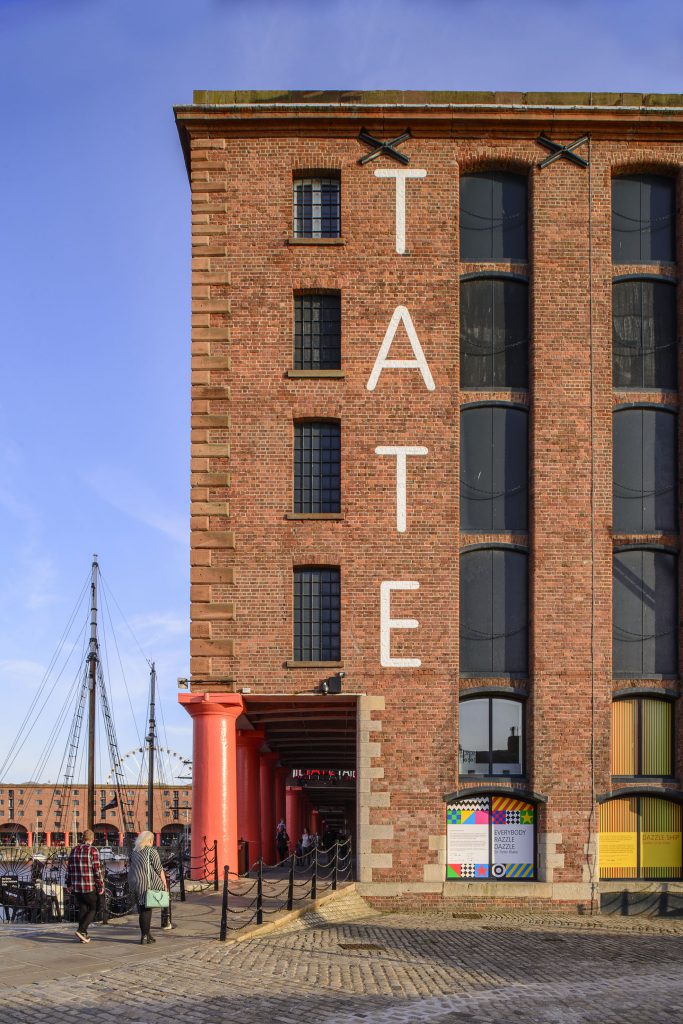 An image of the Tate Liverpool, a red brick building at the dockside.