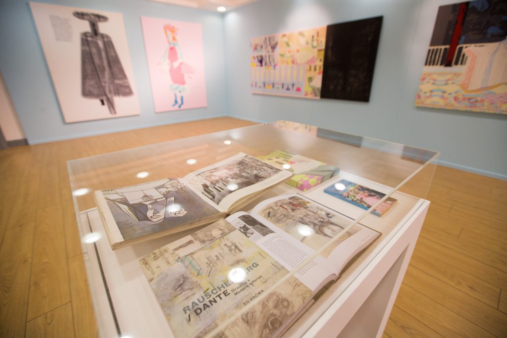 A vitrine in a gallery containing several books.