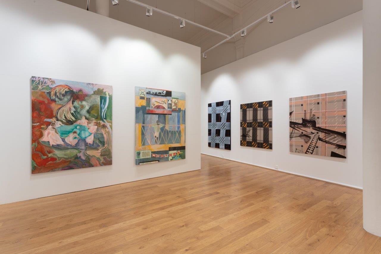 Five paintings hanging in a gallery. The walls are white and the floor is light wood. The paintings are mostly abstract, with beige and black tones, alongside red, blue and yellow highlights.