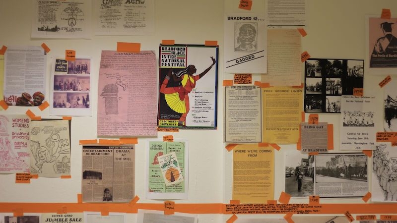 a wall with timeline and pasted materials
