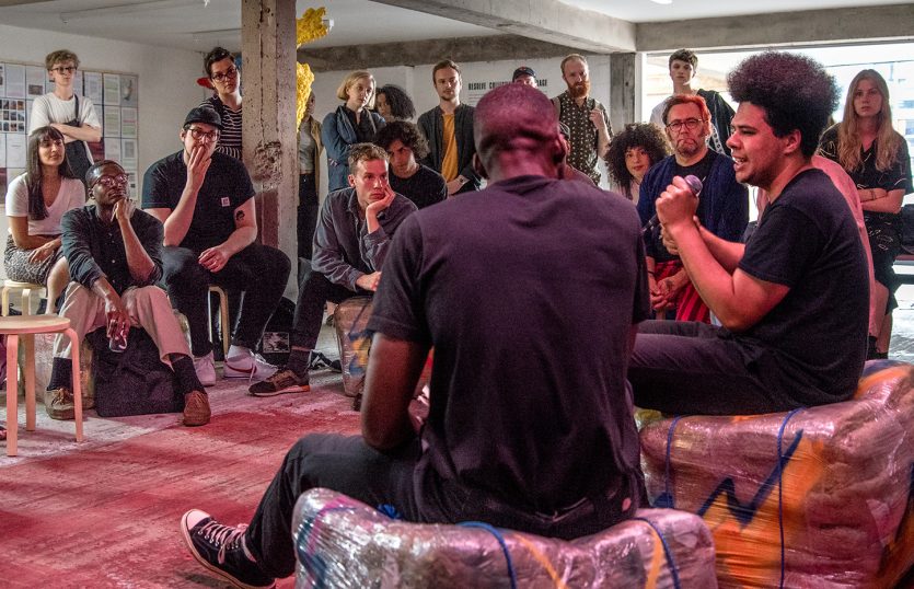 A group of people gathered in an exhibition space.