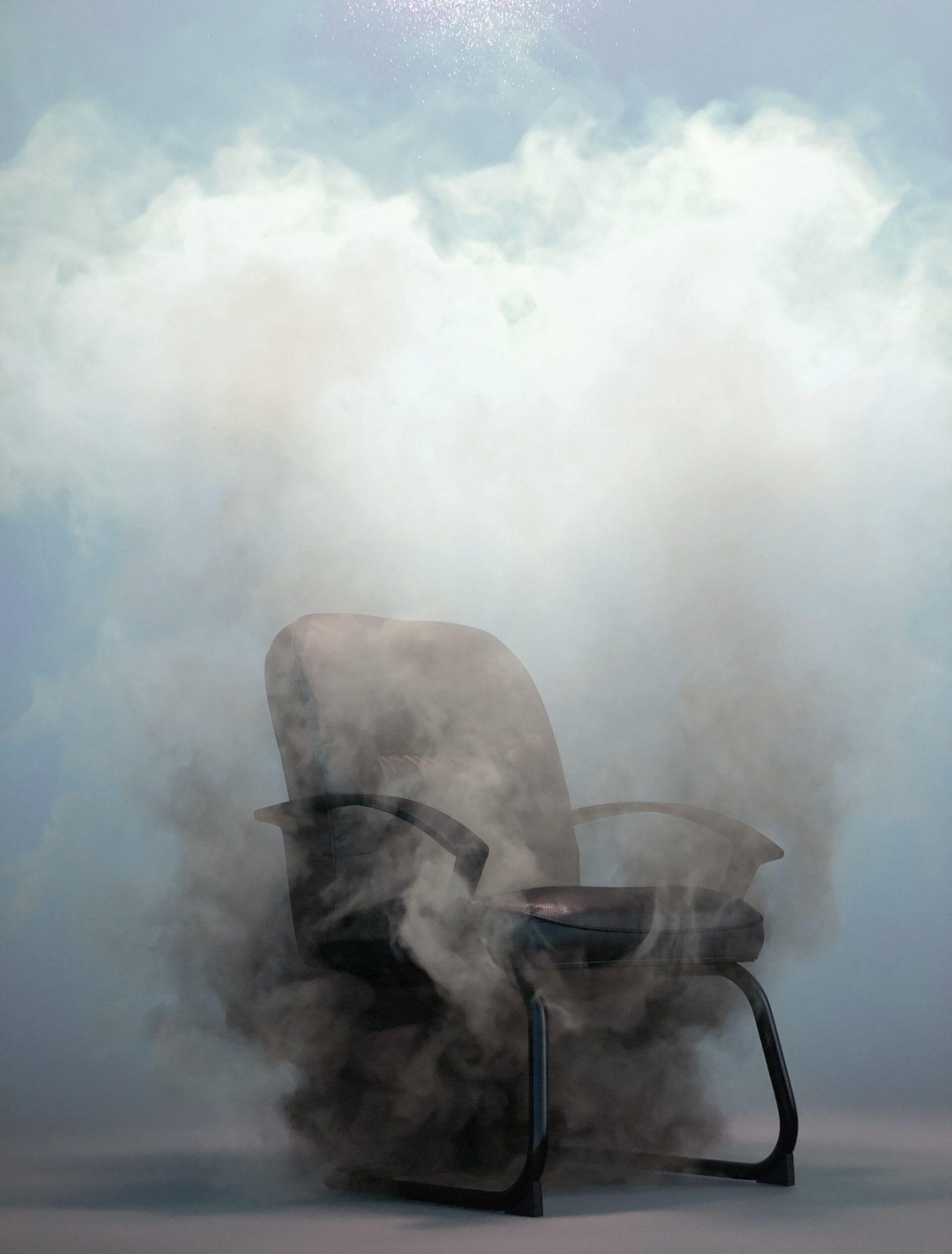 A photograph of an office chair engulfed in smoke.