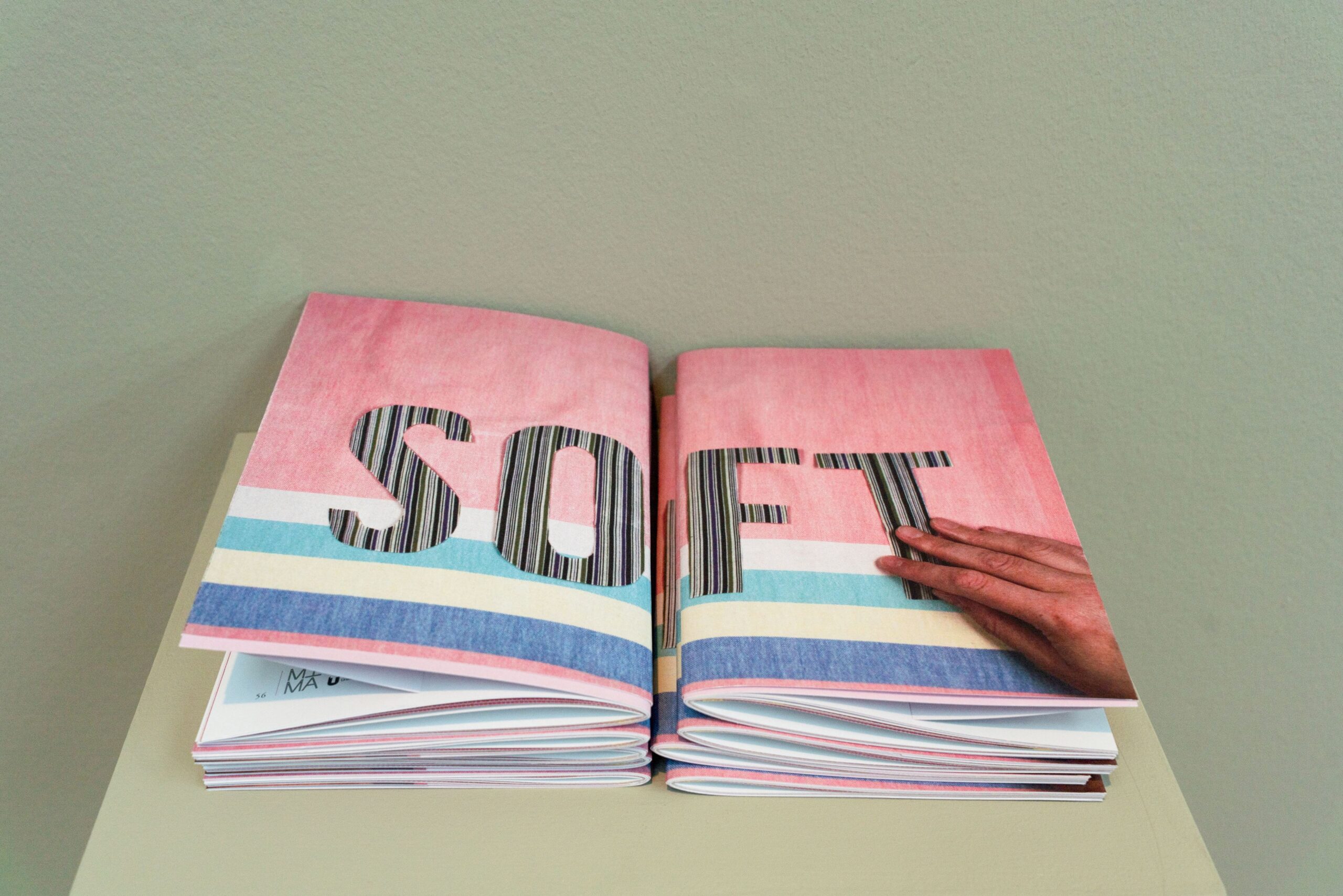 Two stacks of publications on a grey plinth. The jackets read 'SOFT''