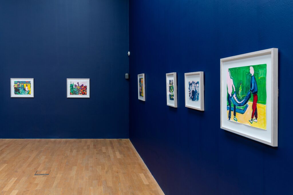 Dark blue wall with brightly coloured ink drawings.