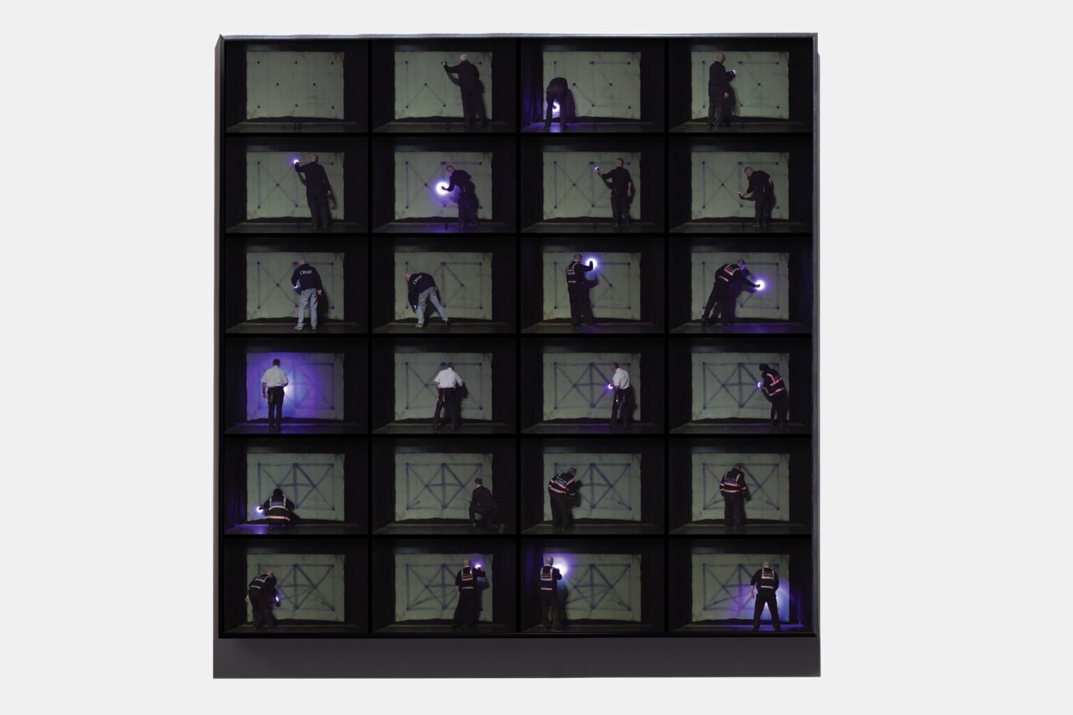 a composite image showing various security staff at Lnacaster University using their torches to creater a geometric drawing on a wall