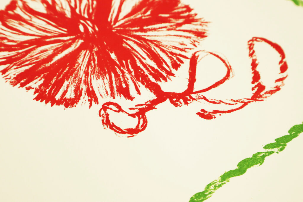 Bright red flower shape with a green cord below
