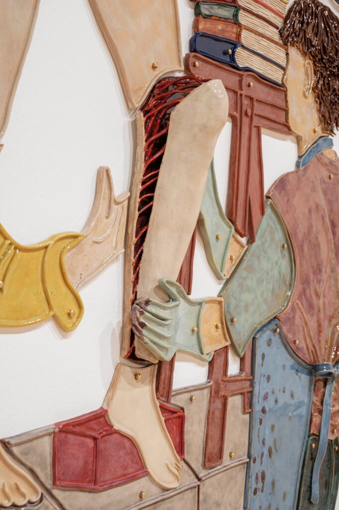 A colourful image showing the back of a person in protective work gear removing the panel of a persons shin with red tendons beneath