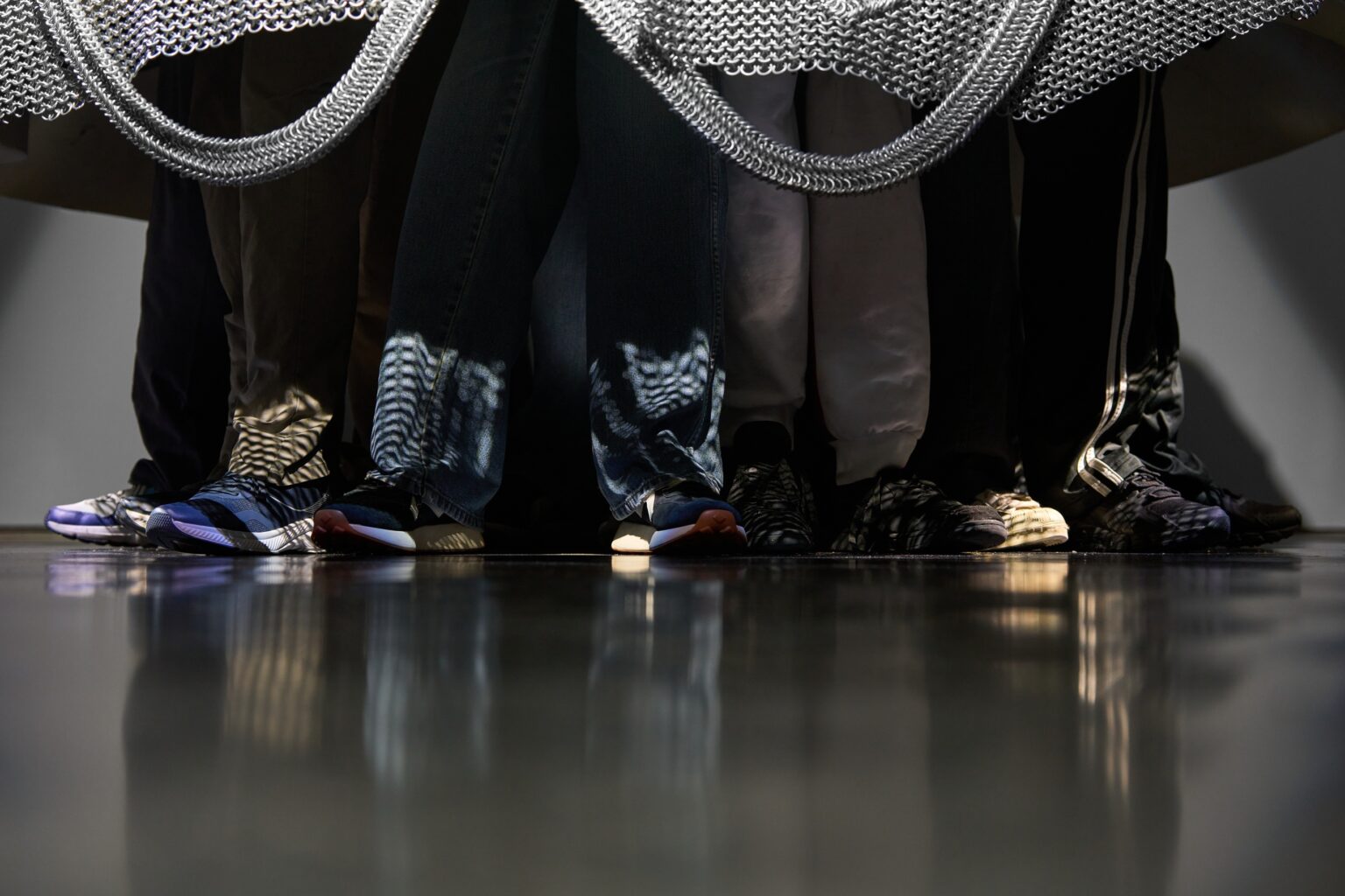 A detail of Amartey Golding's Chainmail 4 showing feet sticking out from under chainmail.